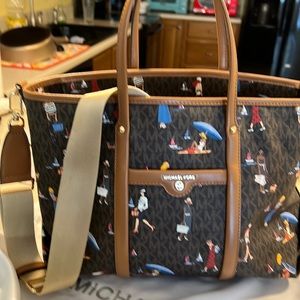 Michael Kors handbag with handles and shoulder strap.